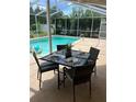 Charming outdoor dining area next to the pool, perfect for alfresco meals and poolside enjoyment at 5342 Sagamore Ct, New Port Richey, FL 34655