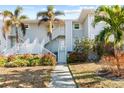 Condominium exterior with mature landscaping, offering a tranquil entrance to this coastal residence at 5850 Gasparilla Rd # M5, Boca Grande, FL 33921