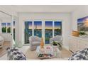 Bright living room features a serene view of the water, comfortable seating, and tasteful coastal decor at 5850 Gasparilla Rd # M5, Boca Grande, FL 33921