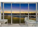 Screened lanai with water views, features seating area perfect for relaxation and enjoying the scenery at 5850 Gasparilla Rd # M5, Boca Grande, FL 33921