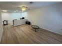 Open concept living room with ceiling fan and modern light wood-look floors at 6165 Chesham Dr # 2, New Port Richey, FL 34653