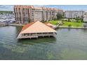 Expansive waterfront community featuring residential buildings, docks, and recreation areas with beautiful clear water views at 634 Edgewater Dr # 744, Dunedin, FL 34698