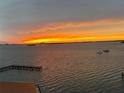 Beautiful sunset view over the water, showcasing vibrant orange and yellow hues at 634 Edgewater Dr # 744, Dunedin, FL 34698