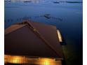 Beautiful waterfront view at twilight featuring a private dock and seawall at 634 Edgewater Dr # 744, Dunedin, FL 34698