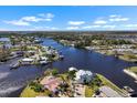 Stunning aerial view of the waterfront property with private docks, a canal and surrounding homes at 829 Blue Heron Blvd, Ruskin, FL 33570