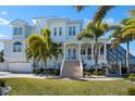 Beautiful home showcasing manicured lawn, a two-car garage, columns and a inviting front porch at 829 Blue Heron Blvd, Ruskin, FL 33570