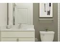 Bathroom with toilet, vanity and mirror features neutral paint and natural light at 9640 Runaway Breeze Dr, Land O Lakes, FL 34637