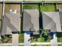 Aerial view showing the roof of a single Gathering home with green grass, nearby properties and neighborhood streets at 10115 Paradise Fish Dr, Riverview, FL 33578