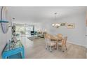 Bright and airy living room with a dining area and sliding glass doors to a balcony at 10215 Regal Dr # 45, Largo, FL 33774