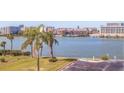 A scenic water view with palm trees and a parking area in the foreground at 10216 Regal Dr # 405, Largo, FL 33774