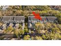 Aerial view highlighting the community layout, lush landscaping, and convenient parking. Arrow indicates subject property at 11320 Harbor Way # 1725, Largo, FL 33774