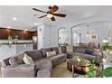 Open concept living area features tile floors, plush seating and an eat-in kitchen at 1426 Main St, Valrico, FL 33594