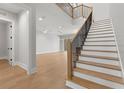 Bright entryway featuring an open staircase with wood treads and wrought iron spindles leading into the living area at 222 N Hesperides St, Tampa, FL 33609