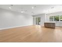 Open floor plan with hardwood floors and bright lighting, showcasing the spacious living area with sliding door at 222 N Hesperides St, Tampa, FL 33609