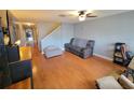 Comfortable living room featuring wood floors, a ceiling fan, and a gray sofa at 310 Kensington Lake Cir, Brandon, FL 33511