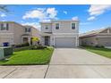 Beautiful two-story home featuring a well-manicured lawn, a two-car garage, and inviting curb appeal at 31386 Penny Surf Loop, Wesley Chapel, FL 33545