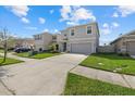 Well-maintained two-story home with a spacious driveway, neat landscaping, and a welcoming entrance at 31386 Penny Surf Loop, Wesley Chapel, FL 33545