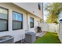 Backyard area with privacy fence, artificial turf, and outdoor grill at 3215 W De Leon St # 6, Tampa, FL 33609