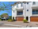 Well-maintained townhome featuring a brick driveway, and manicured landscaping at 3215 W De Leon St # 6, Tampa, FL 33609