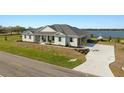 Beautiful home with waterfront views, featuring an attached garage and well-manicured landscaping at 3319 Gulf City Rd, Ruskin, FL 33570