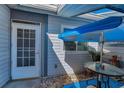 Cozy outdoor patio area with a blue umbrella and table at 39650 Us Highway 19 N # 1422, Tarpon Springs, FL 34689