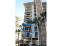 Condo building featuring balconies, stone accents, and tropical landscaping at 5400 Park N St # 200, St Petersburg, FL 33709