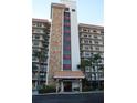 Exterior of condo featuring stone accents, balconies, and tropical landscaping near the entrance at 5400 Park N St # 200, St Petersburg, FL 33709
