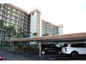 View of parking area beneath condo building with multiple cars at 5400 Park N St # 200, St Petersburg, FL 33709