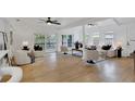 Inviting living room with hardwood floors, neutral decor, and sliding glass doors to the outdoor patio at 5426 Creeping Hammock Dr, Sarasota, FL 34231