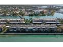 Aerial view showcasing waterfront condominiums surrounded by lush landscaping and scenic waterways, offering a serene living environment at 7560 Bay Island S Dr # 144, South Pasadena, FL 33707