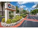 Bay Island entrance featuring manicured landscaping and signage, providing a welcoming feel to the waterfront community at 7560 Bay Island S Dr # 144, South Pasadena, FL 33707