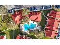 Stunning aerial view of a community pool with ample lounge chairs, lush landscaping and nearby residences at 9481 Highland Oak Dr # 1410, Tampa, FL 33647