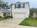 Attractive two-story home featuring a spacious two-car garage, green lawn, and vibrant flower beds at 10908 Carlton Fields Dr, Riverview, FL 33579