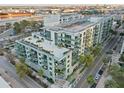 Aerial view of a modern condo building with balconies, palm trees, and rooftop terrace at 111 N 12Th St # 1819, Tampa, FL 33602