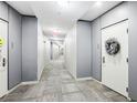 Hallway of condo with doors, grey walls, carpet, and overhead lighting at 111 N 12Th St # 1819, Tampa, FL 33602