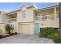 Well-maintained townhome featuring a private garage, attractive front door and manicured landscaping at 12308 Sun Vista W Ct # 45, Treasure Island, FL 33706