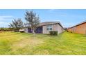 Spacious backyard with a screened lanai perfect for outdoor entertaining and enjoying the serene surroundings at 15644 Aurora Lake Cir, Wimauma, FL 33598