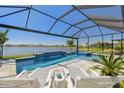 Relaxing screened-in pool and spa area featuring a beautiful lake view at 17441 Savory Mist Cir, Bradenton, FL 34211
