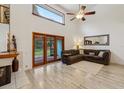 Spacious living room featuring high ceilings, wood floors, fireplace, and natural light at 1814 Cypress Trace Dr, Safety Harbor, FL 34695