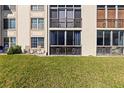 Building exterior with grassy yard and patio seating, perfect for relaxing and enjoying the outdoors at 19029 Us Highway 19 N # 7-9, Clearwater, FL 33764