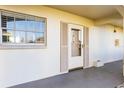 Inviting front entrance featuring a white door with glass and neutral colored shutters at 19029 Us Highway 19 N # 7-9, Clearwater, FL 33764