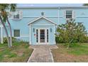 Charming two-story home with a brick pathway and a vibrant blue exterior at 209 Seahorse Se Dr # D, St Petersburg, FL 33705