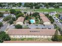 Aerial view of Building F, the pool, and the parking lot surrounded by mature trees at 2500 Harn Blvd # F22, Clearwater, FL 33764