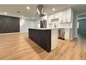 Modern kitchen with white cabinets, stainless steel appliances, and a stylish island at 2602 Surrey Dr, Palm Harbor, FL 34684