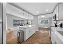 Bright, open-concept kitchen with a center island, sleek countertops and views of the pool at 3104 Bay St, Sarasota, FL 34237