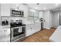 Modern kitchen showcasing stainless steel appliances, white cabinetry, and subway tile backsplash at 3104 Bay St, Sarasota, FL 34237