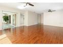 Bright and airy living room with elegant wood floors, ceiling fans, and a view of the lanai at 3416 Annette Ct # 71, Clearwater, FL 33761