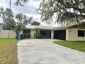 Single story home with metal roof, black framed windows, stone accent and updated driveway at 3608 Oak Bark Ln, Brandon, FL 33511