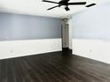 Spacious living room featuring modern lighting, and durable, dark-toned laminate flooring at 3608 Oak Bark Ln, Brandon, FL 33511