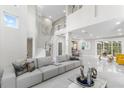 Bright and spacious living room boasting high ceilings, a modern staircase, and sleek marble floors at 375 Wellington Ave, Oldsmar, FL 34677